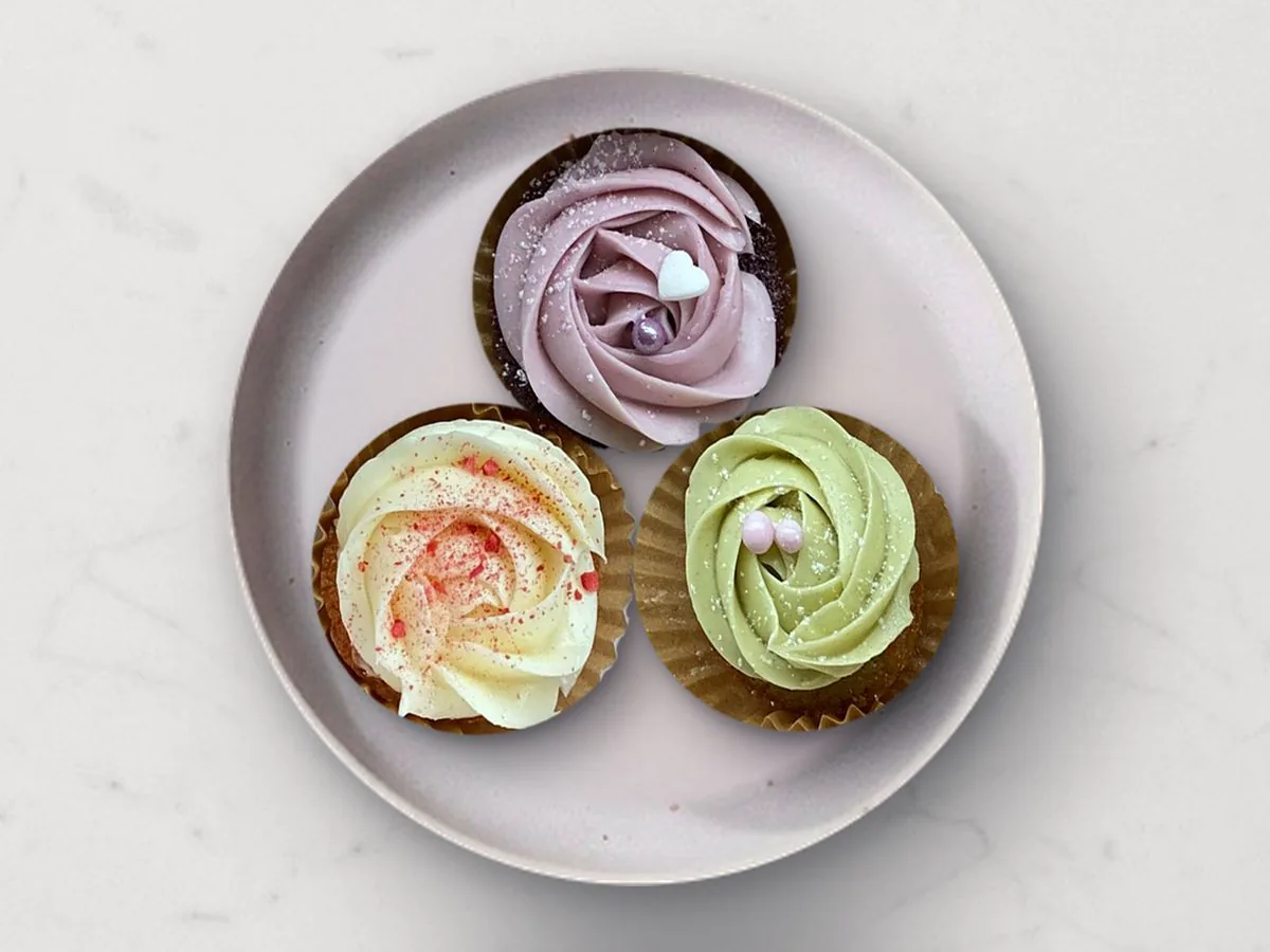 Three Mini Mochi Cupcakes with ube, matcha and classic buttercream on a lilac plate